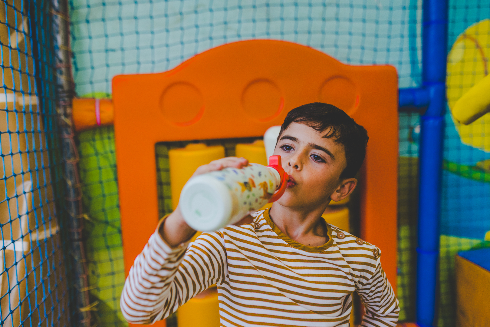 Dítě pijící z termo láhve Cool Bottles se sportovním víčkem – snadné otevírání a uzavírání pro malé děti.